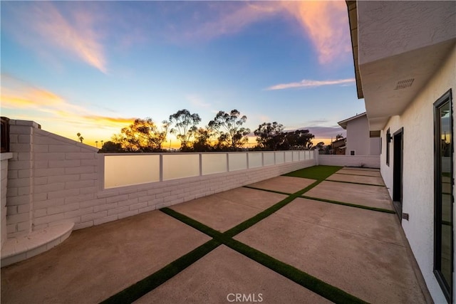 view of patio terrace at dusk