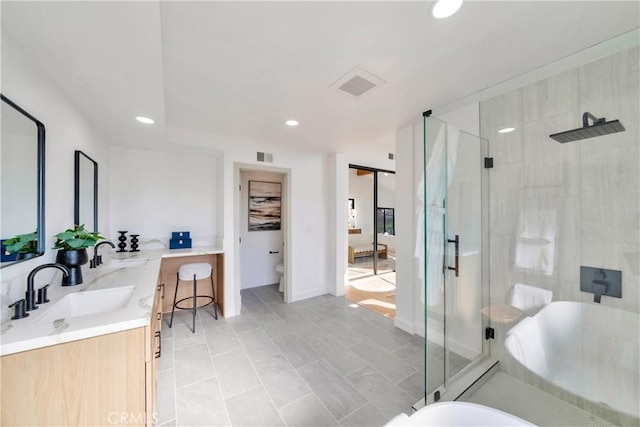 bathroom with toilet, tile patterned floors, walk in shower, and vanity