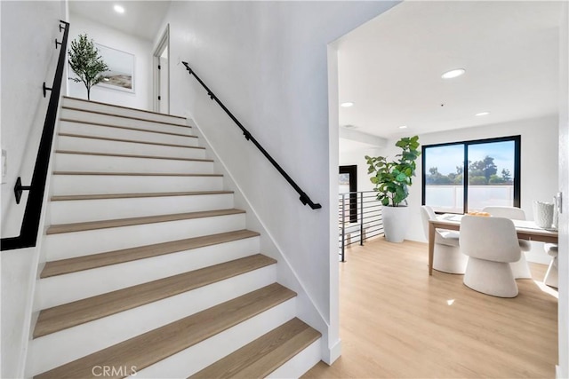 stairway with hardwood / wood-style floors