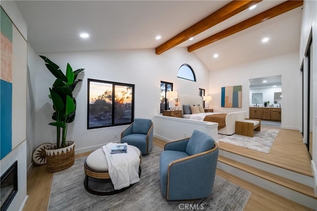 living room featuring lofted ceiling with beams and hardwood / wood-style flooring