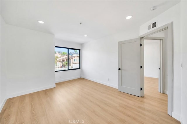 spare room featuring light hardwood / wood-style flooring