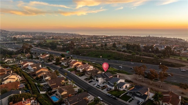 aerial view at dusk with a water view