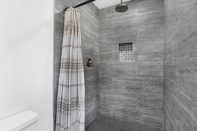 bathroom featuring toilet and a shower with curtain