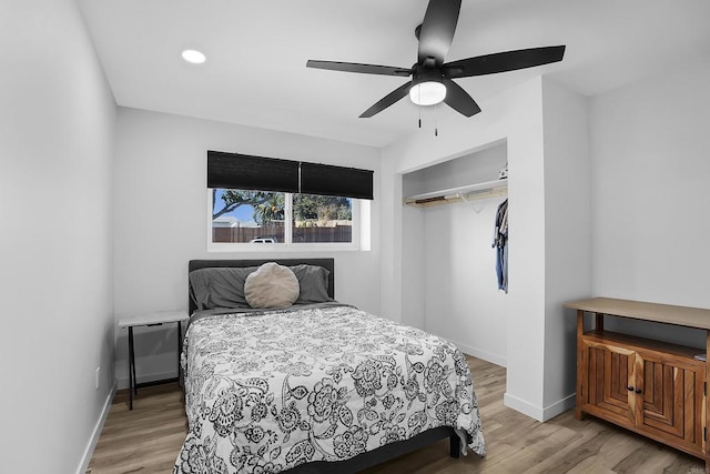 bedroom with ceiling fan, a closet, and light hardwood / wood-style flooring