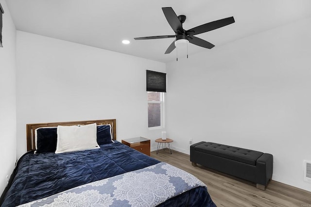 bedroom with ceiling fan and wood-type flooring