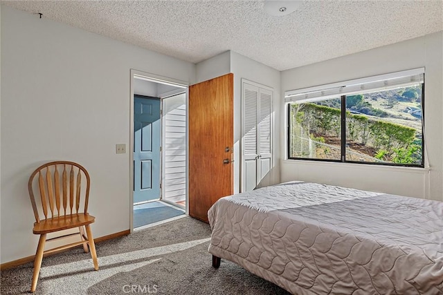 bedroom featuring a textured ceiling, a closet, and carpet flooring