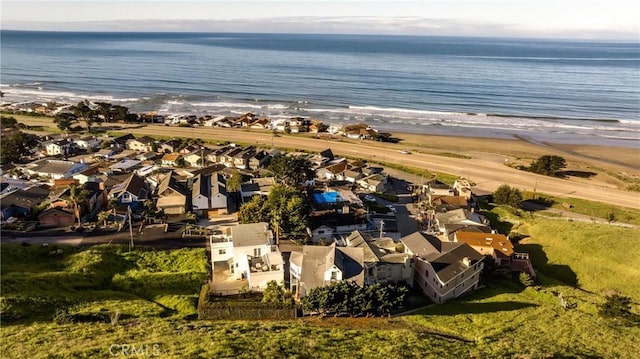 drone / aerial view featuring a water view and a beach view