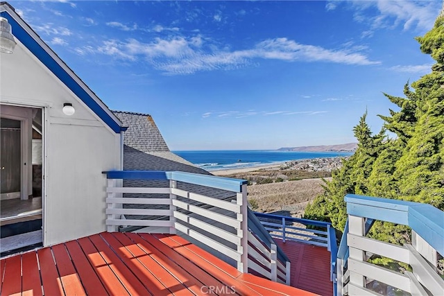 deck featuring a beach view and a water view