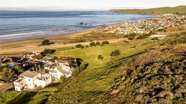 bird's eye view featuring a water view and a beach view