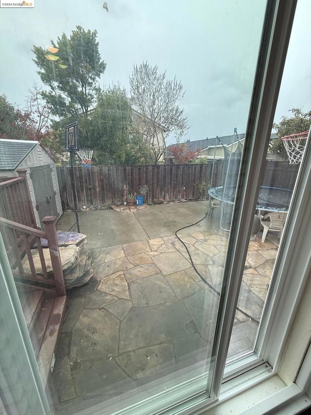 view of patio featuring a shed and a trampoline