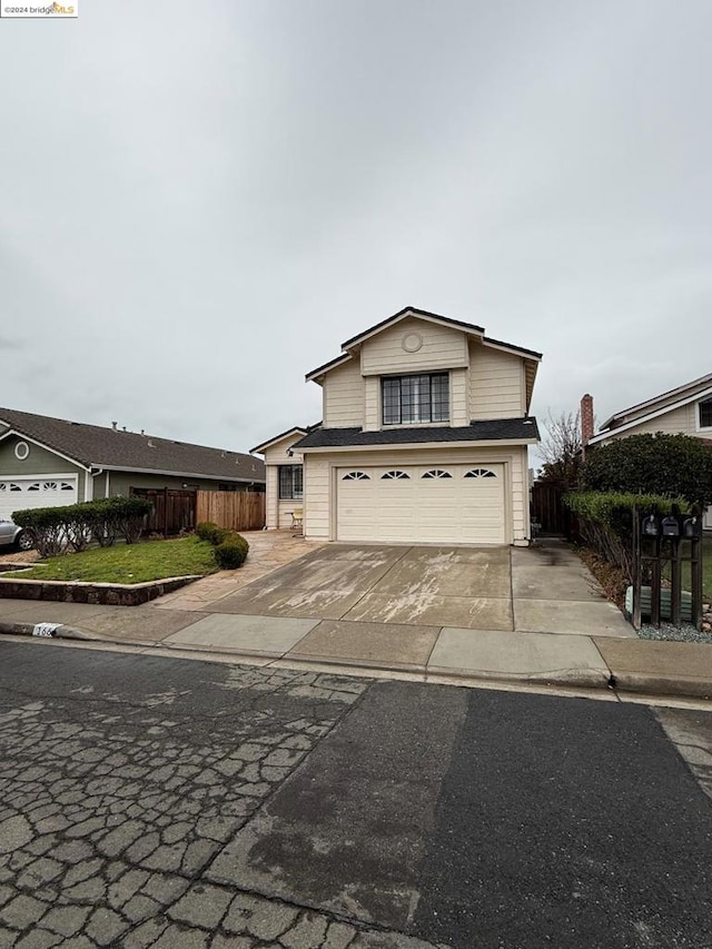 view of front of house with a garage and a front lawn