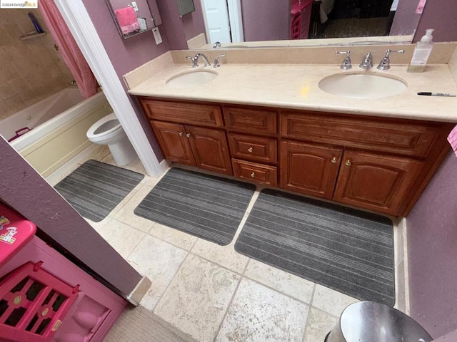 full bathroom with washtub / shower combination, tile patterned floors, vanity, and toilet