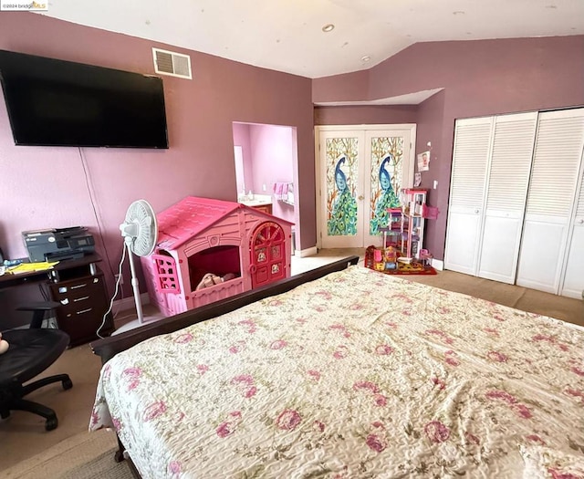 carpeted bedroom featuring french doors, vaulted ceiling, and a closet