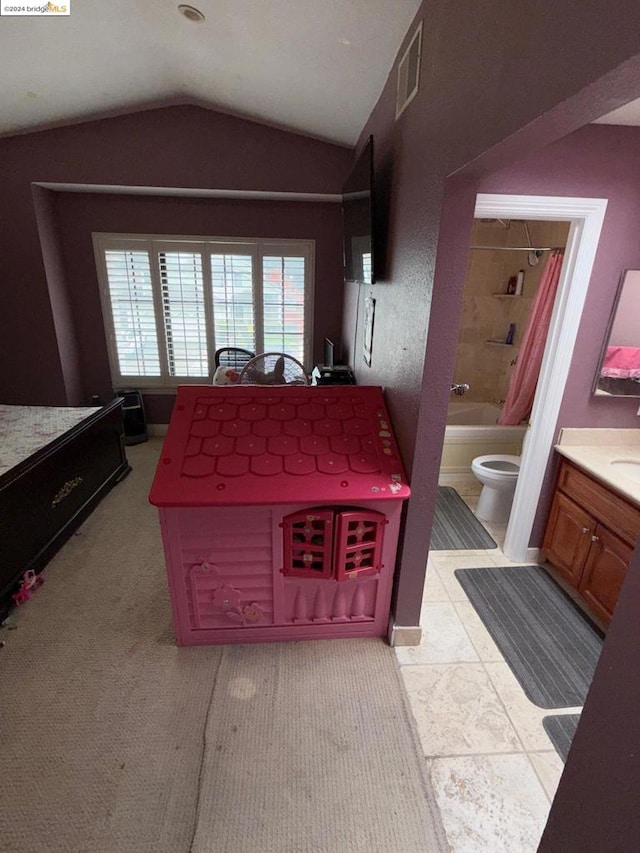 interior space featuring shower / bathtub combination with curtain, vanity, toilet, and lofted ceiling