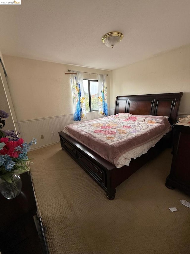 carpeted bedroom with wood walls and billiards