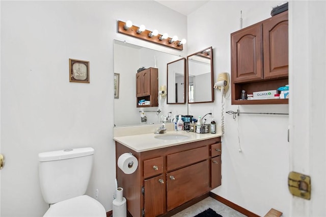 bathroom featuring vanity, tile patterned flooring, and toilet