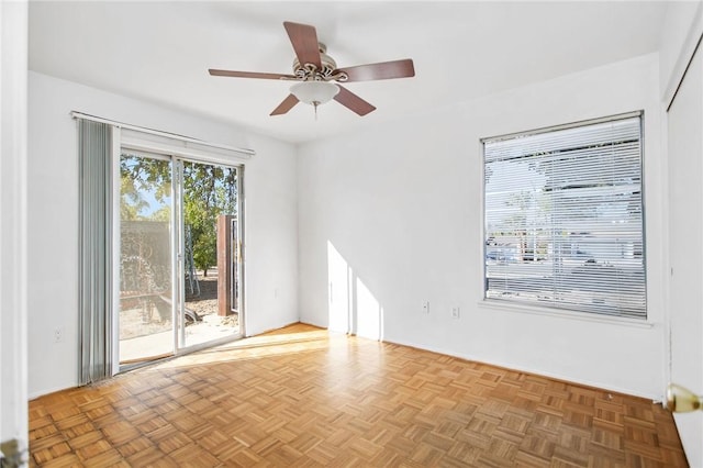 empty room with light parquet flooring and ceiling fan