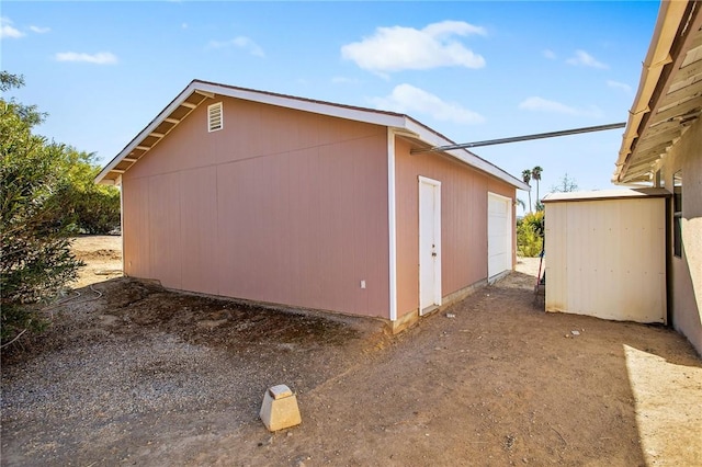 view of home's exterior with a garage and an outdoor structure