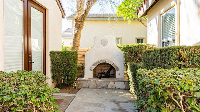 view of patio / terrace featuring an outdoor stone fireplace