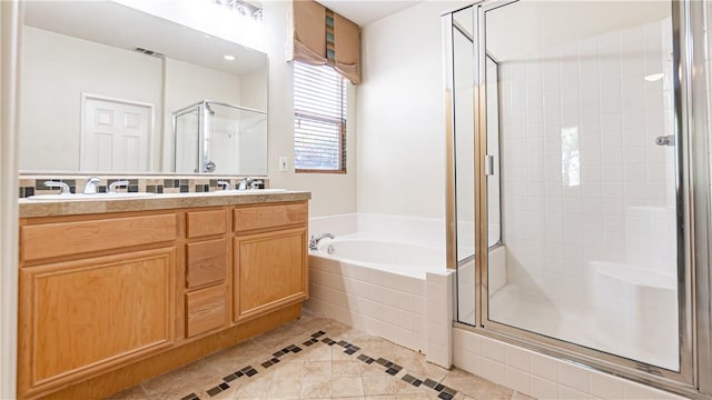 bathroom featuring shower with separate bathtub, vanity, and tile patterned floors