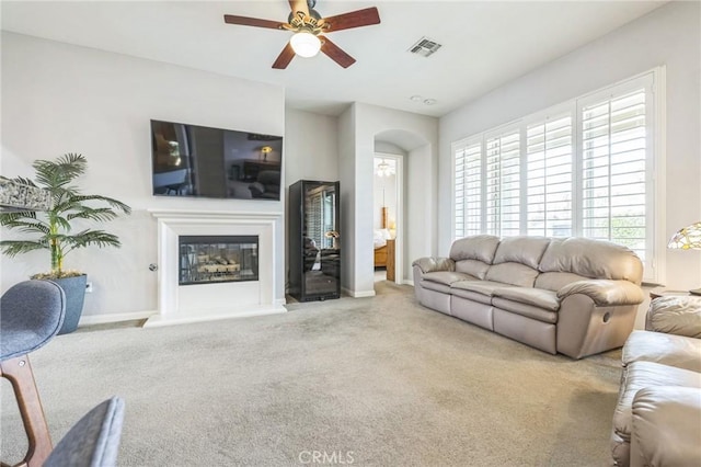 living room featuring ceiling fan and carpet floors