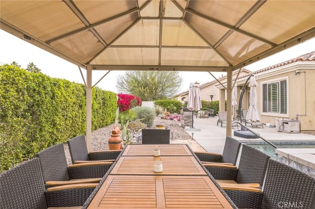 view of patio / terrace featuring a gazebo and a swimming pool