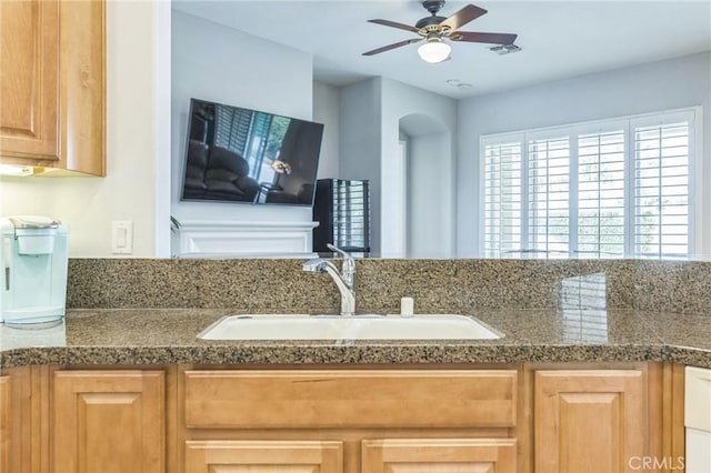 kitchen featuring ceiling fan and sink