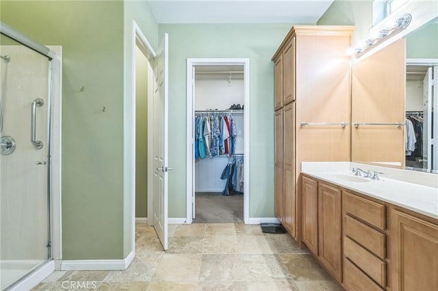 bathroom with vanity and a shower with door