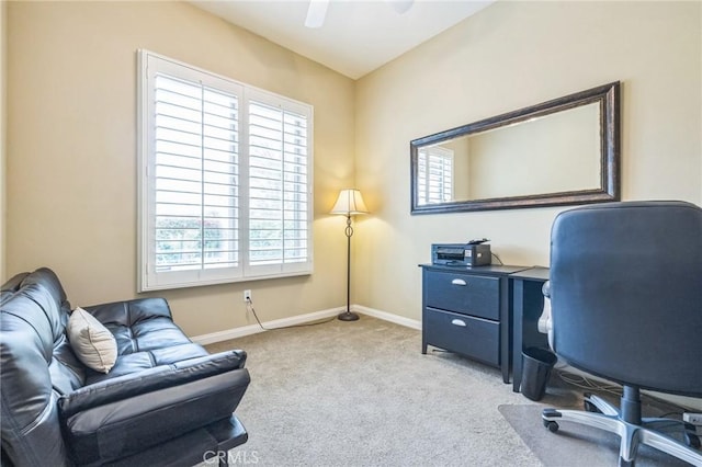 office featuring plenty of natural light, ceiling fan, and light colored carpet