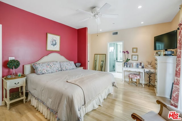 bedroom featuring ceiling fan, connected bathroom, and light wood-type flooring