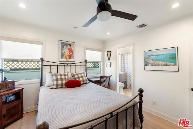 bedroom featuring ceiling fan, connected bathroom, and light hardwood / wood-style flooring