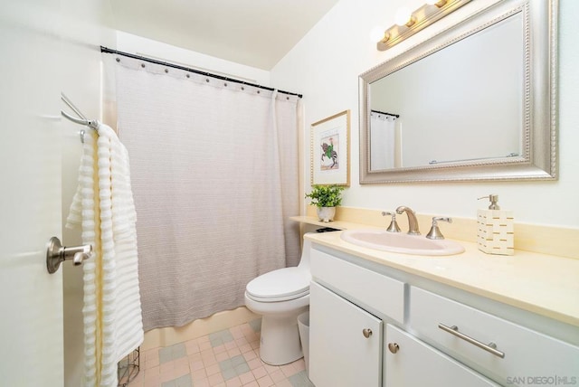 bathroom with vanity, tile patterned floors, and toilet