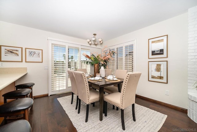 dining area featuring an inviting chandelier and dark hardwood / wood-style flooring