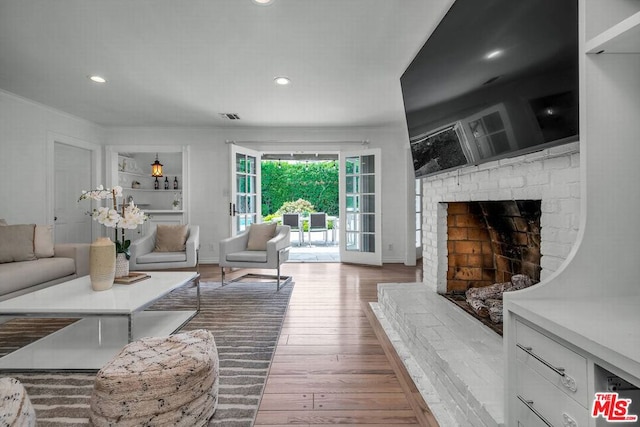 living room with a fireplace and hardwood / wood-style floors