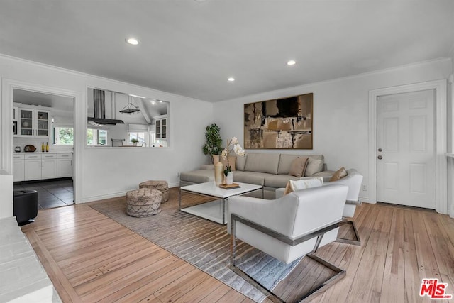 living room featuring hardwood / wood-style flooring and ornamental molding