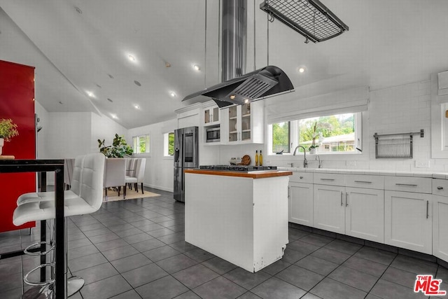 kitchen featuring white cabinets, stainless steel fridge, and a kitchen island