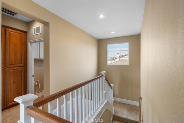 stairway with recessed lighting, visible vents, and baseboards