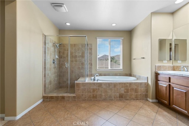 full bathroom with a garden tub, vanity, a shower stall, tile patterned flooring, and baseboards