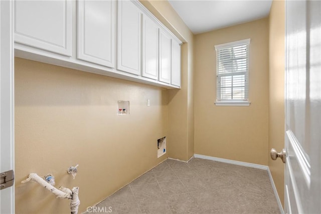 clothes washing area featuring light tile patterned floors, gas dryer hookup, baseboards, cabinet space, and washer hookup