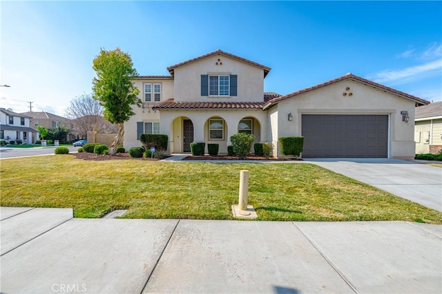 mediterranean / spanish-style house with a garage and a front yard