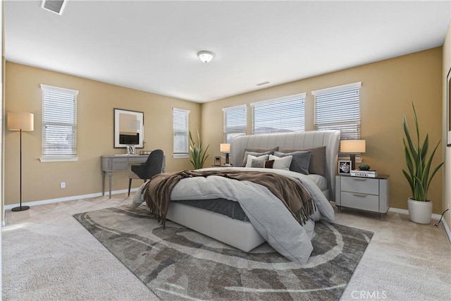 bedroom featuring carpet flooring, multiple windows, and visible vents