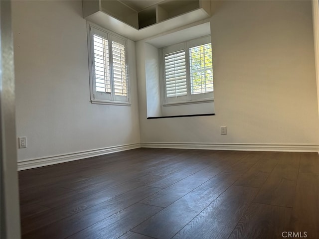 empty room featuring dark wood-type flooring