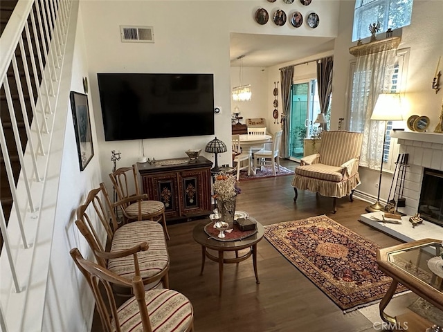 living room with wood-type flooring and an inviting chandelier