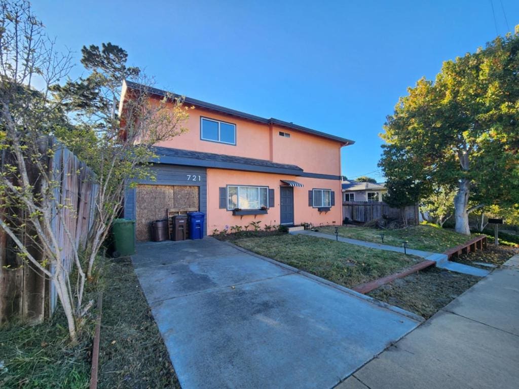 rear view of house with a lawn