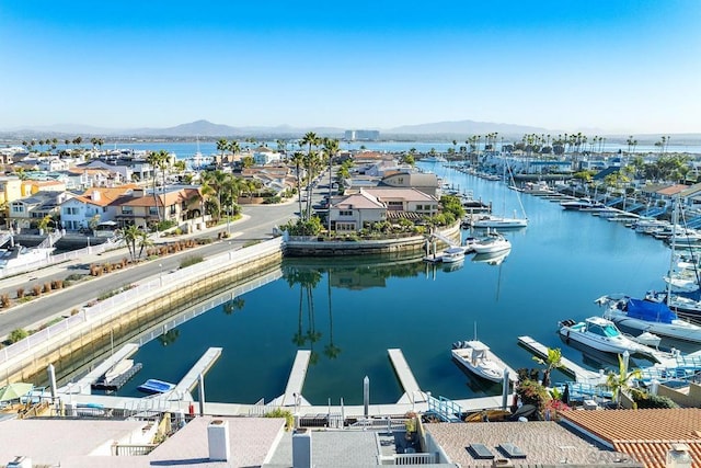 drone / aerial view featuring a water and mountain view