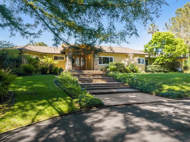 ranch-style house featuring a front yard