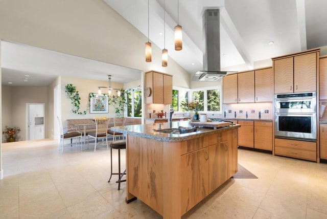 kitchen with pendant lighting, high vaulted ceiling, decorative backsplash, double oven, and island range hood