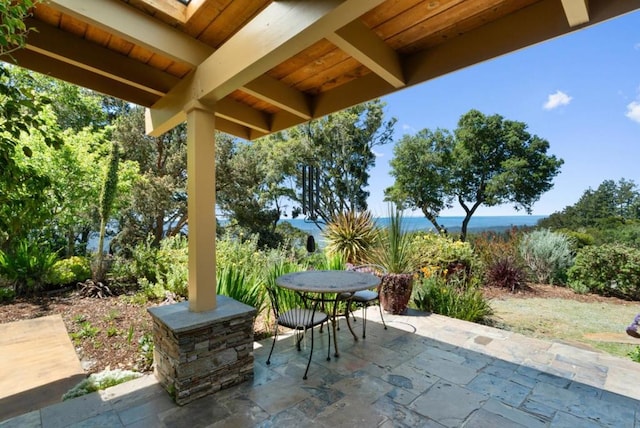 view of patio with a water view