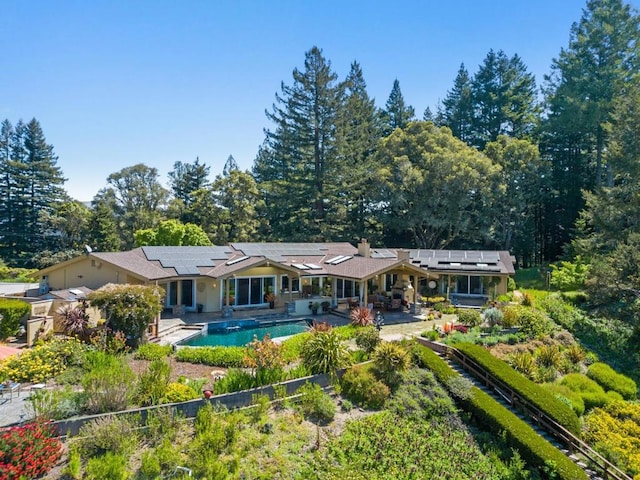 rear view of property featuring a patio area