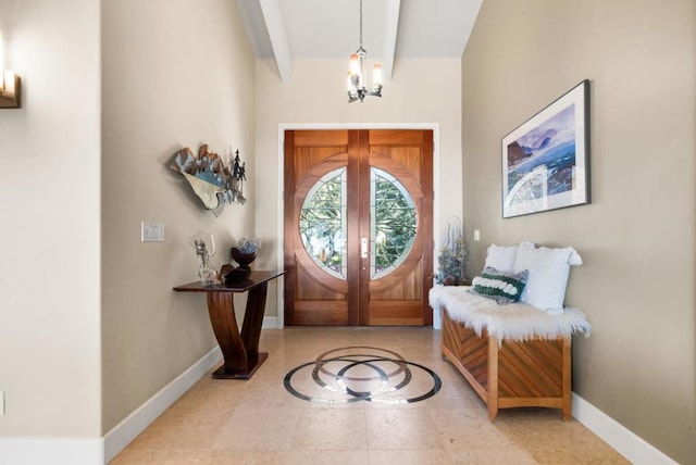 foyer featuring beam ceiling, tile patterned floors, french doors, and a chandelier